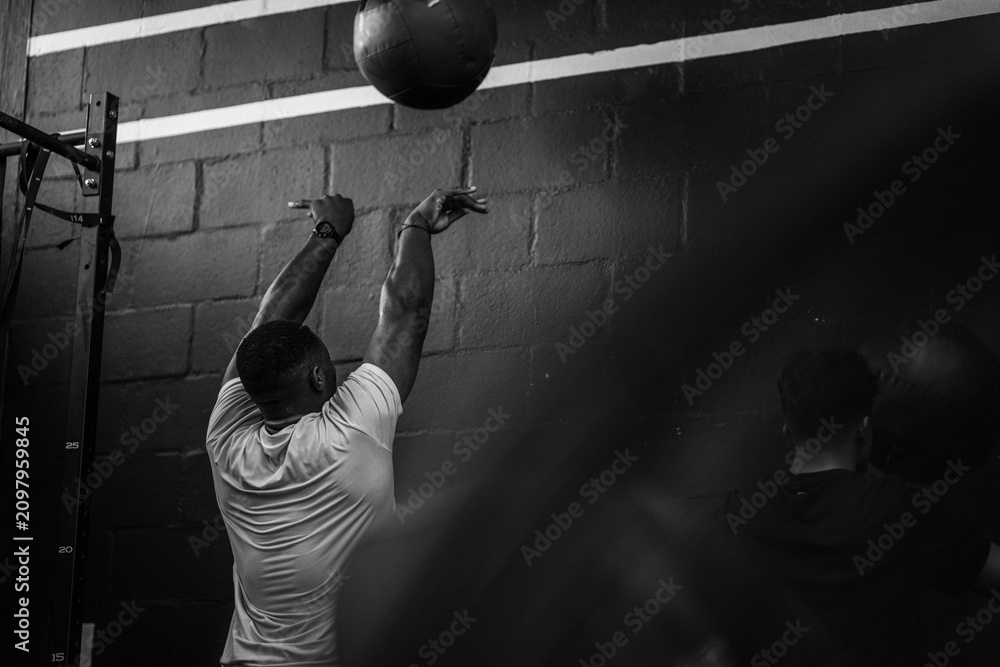 Obraz premium Cross fit Hyrax training exercises medicine ball wall throw