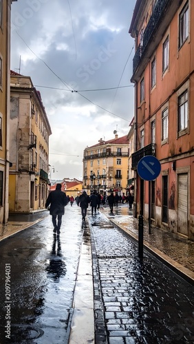 Rainy cobblestone street in historic European town.