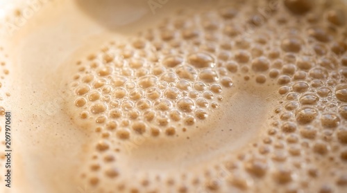 Macro Close-up Shot of Frothy Coffee Foam with Tiny Bubbles in a Cup