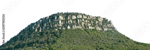 Isolated rocky hill rising above rural landscape
