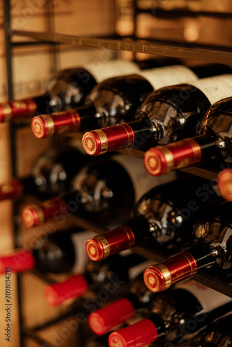 Wine Bottles Stored on Rack in Cellar
Close Up of Wine Bottles in Wooden Rack
Elegant Wine Storage with Bottles on Shelf