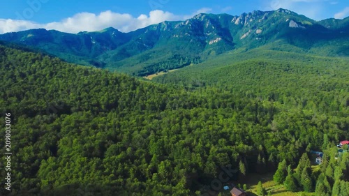 Aerial footage with the Ciucas mountains in Romania in summer. A scenic mountain view in the area of ​​the Cheia resort in the Carpathian mountains