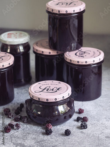 Stack of jars of homemade blackberry jam with the text 