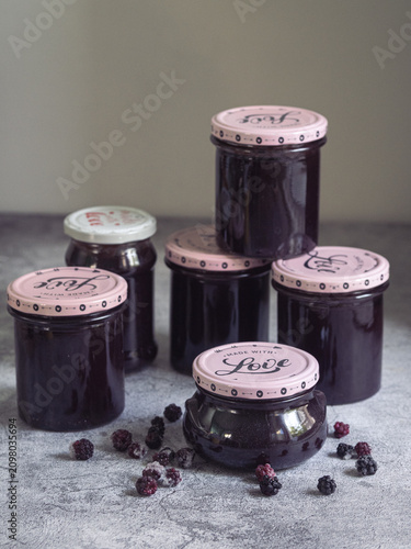 Stack of jars of homemade blackberry jam with the text 