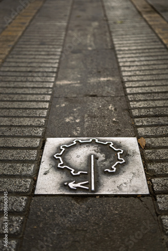 Fotografie Metal Symbol Embedded in Pavement in Nicosia, Cyprus
