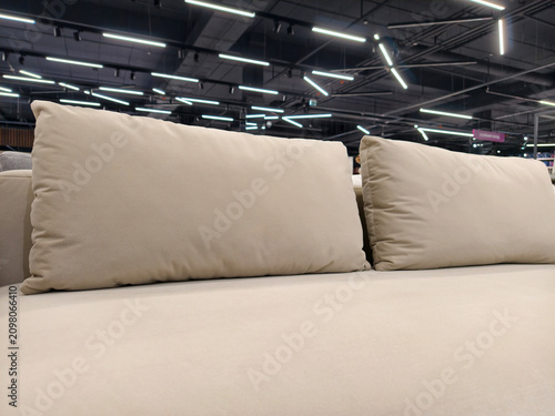 Quadro su tela A cozy gray couch with oversized, elongated cushions, available in the furniture