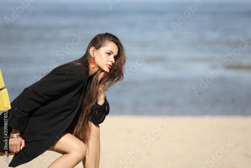 Elegant Young Woman Relaxing on Sunny Beach Chair