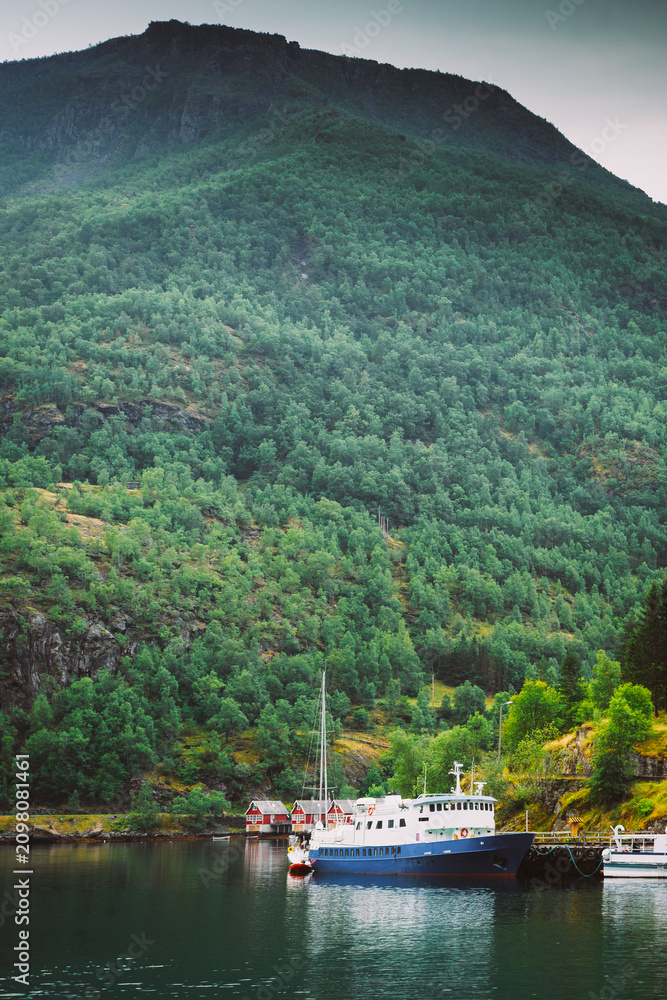 Fototapeta premium A passenger cruise ship docked in the deep, scenic Aurlandsfjord near Flam.