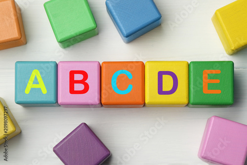 Canvastavla Alphabet. Wooden cubes with letters on white background, top view