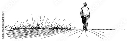 Fotografie Man walking away on path towards the horizon through grassy field in vintage eng