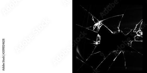 Schilderij op canvas Close-up of shattered glass with sharp fragments on a dark background with white