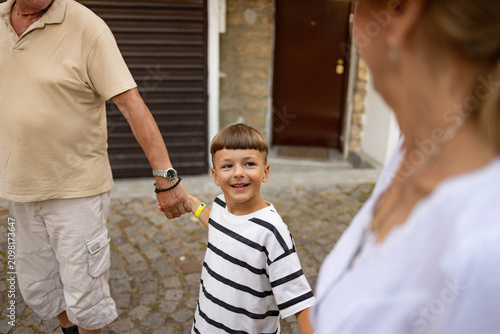 Quadro em tela Grandparents and grandson exploring the old town