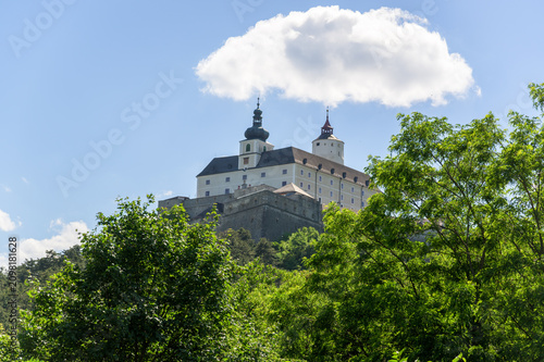 Canvastavla Esterhazy Castle stands majestically atop a hill surrounded by vibrant green tre
