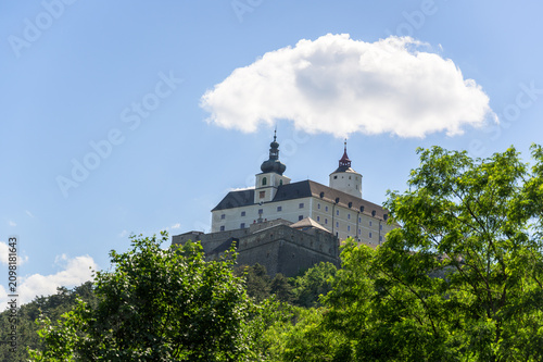 Konstfotografi Esterhazy Castle is prominently situated atop a rocky hill, surrounded by lush g
