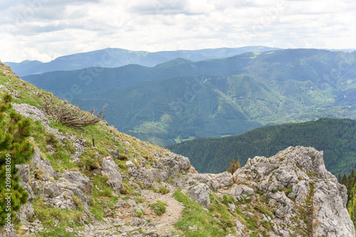 Cuadro en lienzo A breathtaking view of Rax Mountain in Austria reveals lush green valleys and ru