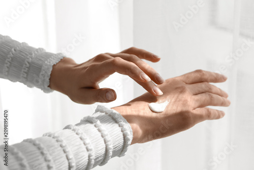Woman applying moisturizing...