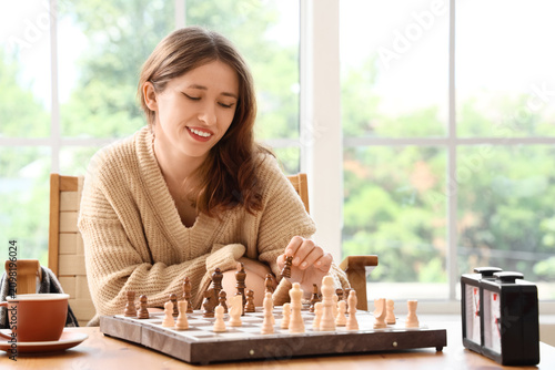 Smiling young woman playing...