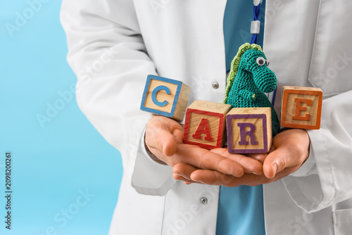 Male pediatrician holding c...