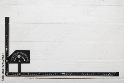 Builders ruler on white woo...