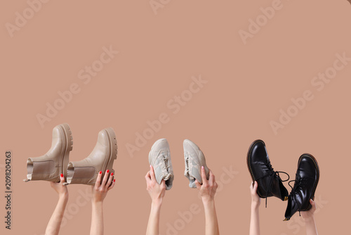Female hands holding boots ...