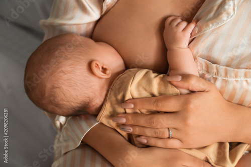 Young woman breastfeeding h...