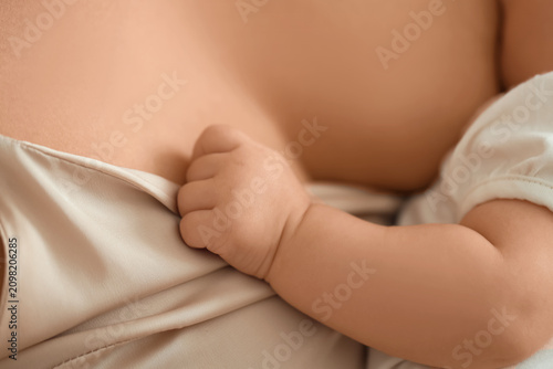 Young woman breastfeeding h...
