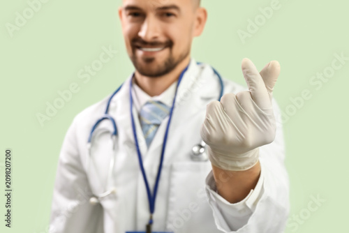 Male doctor making heart wi...