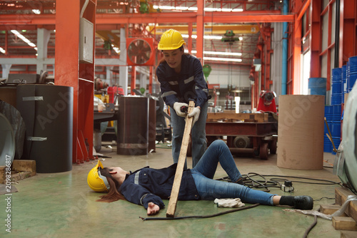 Fotografie A female employee is helping her friend who was electrocuted in a metal cheese factory