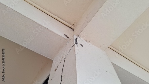 Structural crack on concrete pillar and ceiling beam corner