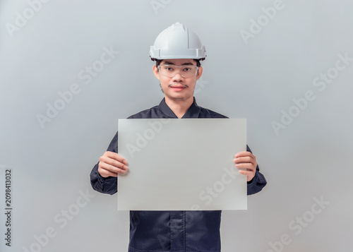 Konstfotografi Asian male engineer holding large blank horizontal poster board