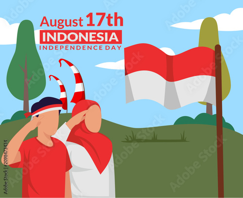 A young Indonesian couple salutes the red and white flag to celebrate Indonesian Independence Day, August 17th