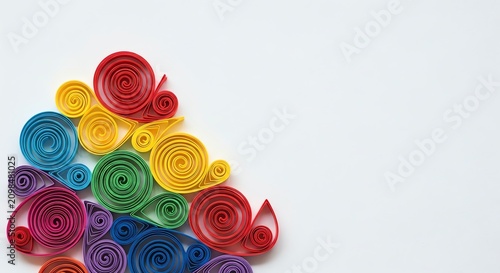 Colorful quilled paper swirls arranged on a white background