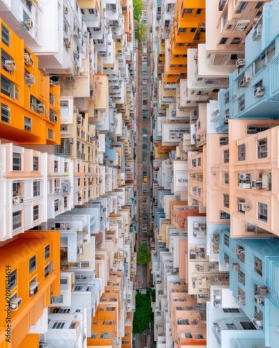 Vertical aerial shot of a dense residential district in Hong Kong, repetitive patterns of rooftops and air conditioners, muted urban colors