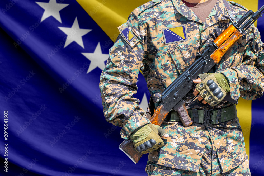 Fototapeta premium Bosnia and Herzegovina flag with soldier holding assault rifle