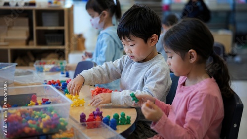 Diverse Young Children Engaged in Creative Play with Colorful Counting Bears at a Classroom Table, Early Childhood Development and Education Concept