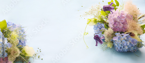 фотографія floral background of a bouquet on a blue background, hygrangeas, smoke tree and