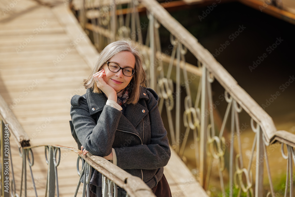 Fototapeta premium Enjoying a peaceful moment on a charming wooden bridge during the golden hour
