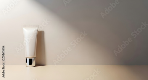 White cosmetic tube on beige surface with hard shadow.