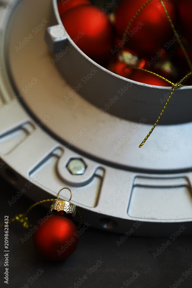Fototapeta premium Red Christmas Ornaments on Industrial Metal Surface: Festive Holiday Decor Concept
