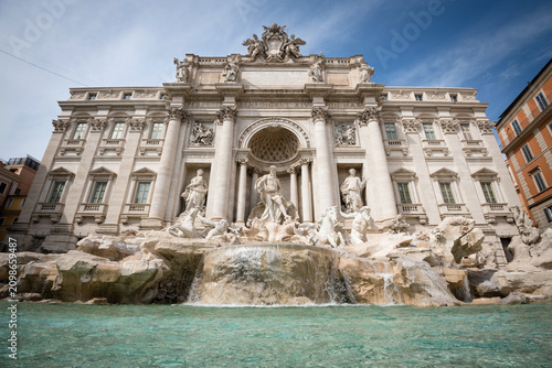 Wide angle panoramic view of the majestic Trevi Fountain with turquoise water and waterfall in Rome, Italy