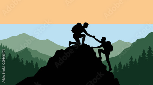 Silhouette of two hikers helping each other climb a mountain at sunrise