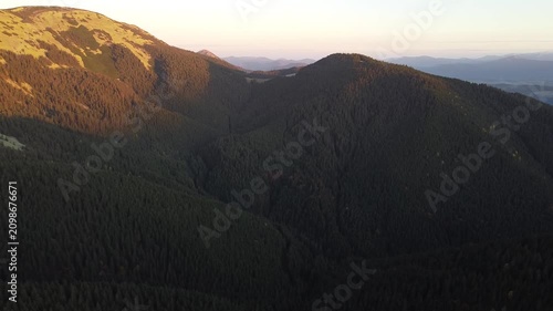 Aerial Sunset Flight Over Autumn Mountain Ridge and Dark Forest Hills