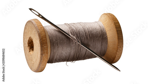 Tableau sur toile Wooden spool of grey thread with a metal needle, isolated on transparent backgro