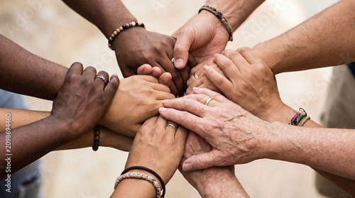 Multi-ethnic and Multi-generational Group of People Joining Hands in a Circle, Symbolizing Unity, Solidarity, and Community Support
