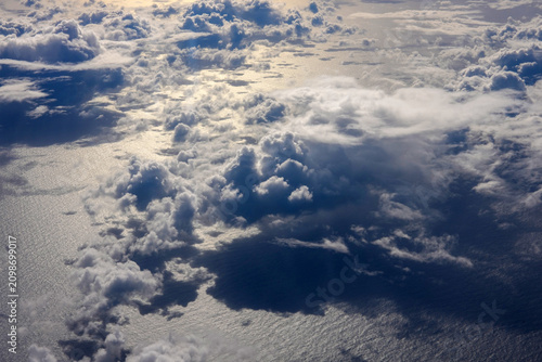 Cloud formations are reflected on the surface of the ocean in the early morning.