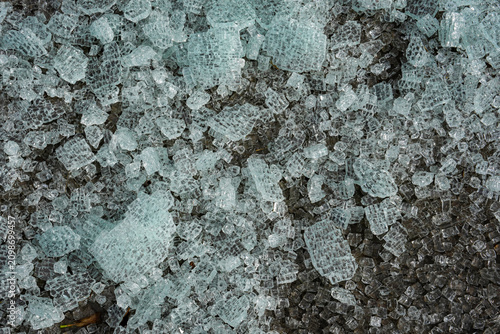 Broken glass from a safety window lies scattered on the ground.