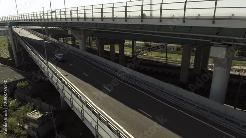 A retro Volga car from the days of the USSR is driving on an overpass in the city