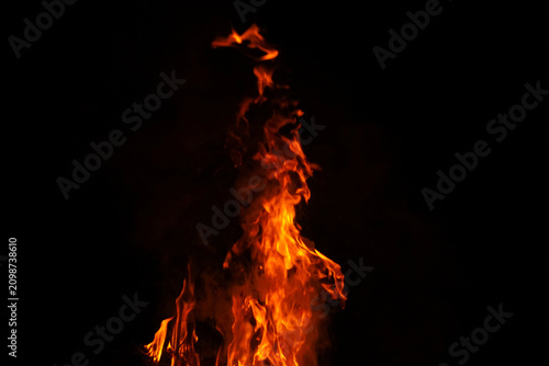 Konstfotografi Bright orange flames burning against a dark black background, creating a dramati