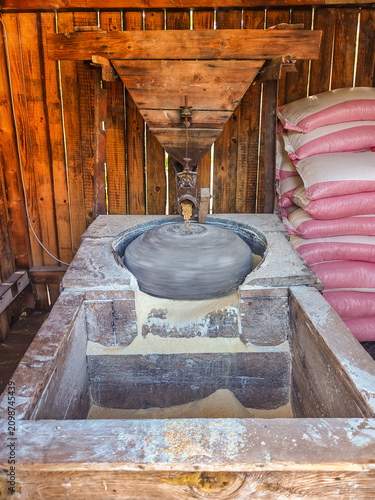 Traditional Wooden Mill Grinding Corn into Flour
