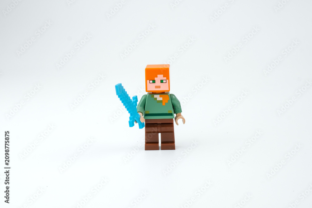Obraz premium A Minecraft-style block toy character holds a blue sword on a white background. Suitable for pixel game characters on Apr 13, 2026 in Jakarta, Indonesia